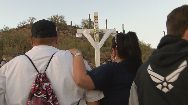 Dozens carry cross up A-mountain on Good Friday