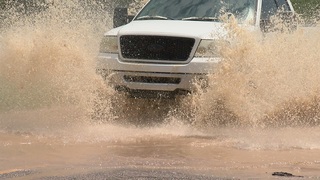 Storms cause running washes and flooded roads